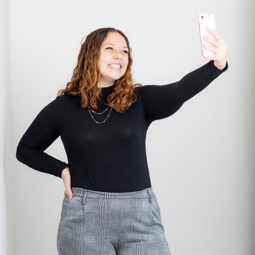 Jillian Lawrence smiling while taking a selfie, showcasing her expertise in digital storytelling.